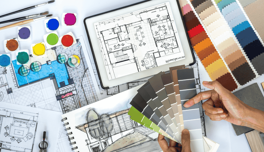 Architect, interior designer working at worktable with color swatch, sketch