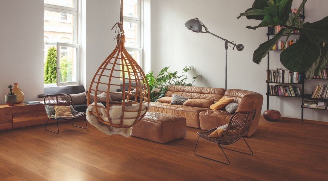 Interior of living room with tall windows and laminate timber flooring