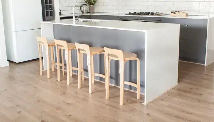 Kitchen with Wooden stools on Laminate Floor