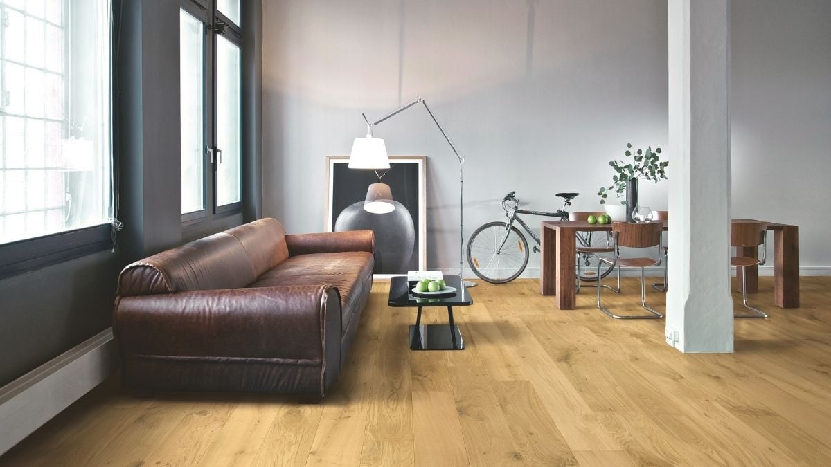 Textured timber flooring in living room and dining room of industrial home