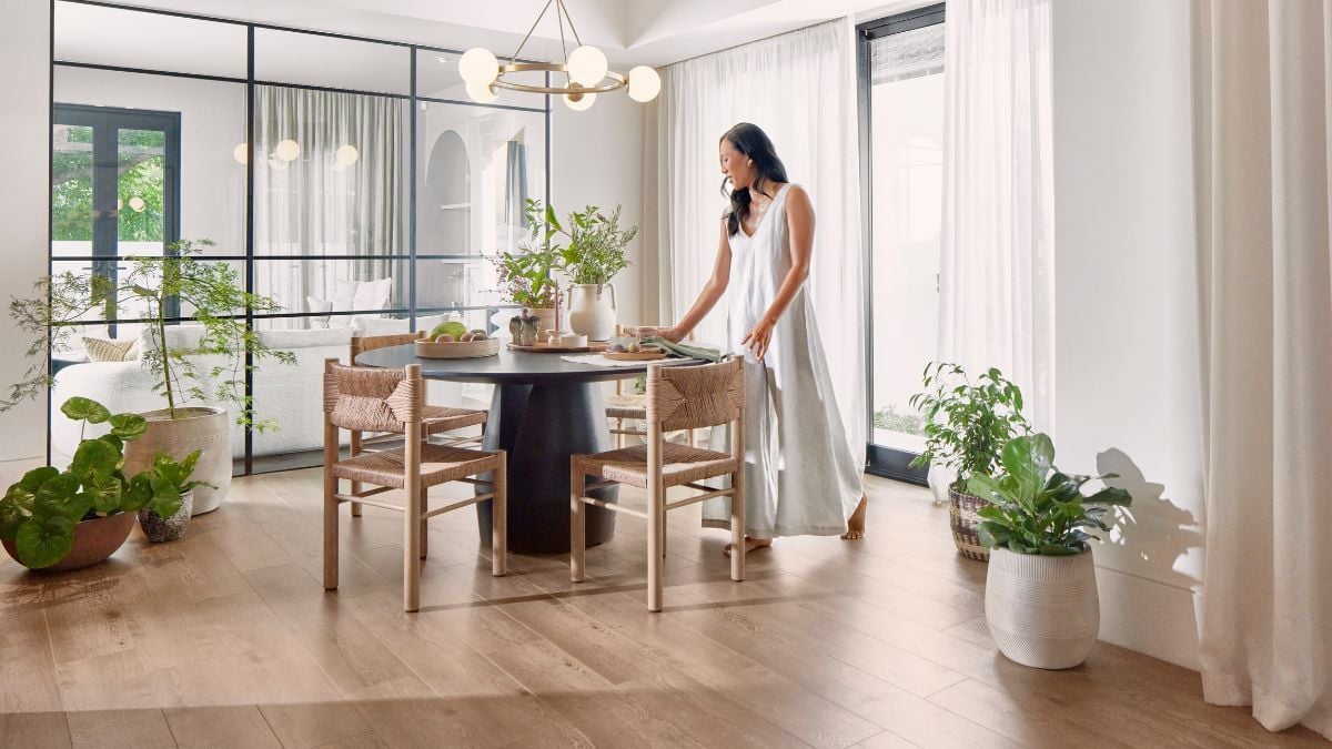 Woman in dining room with curtains and modern design