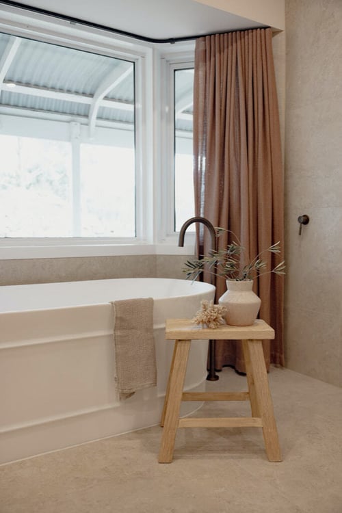 bathroom interior with open curtain and windows