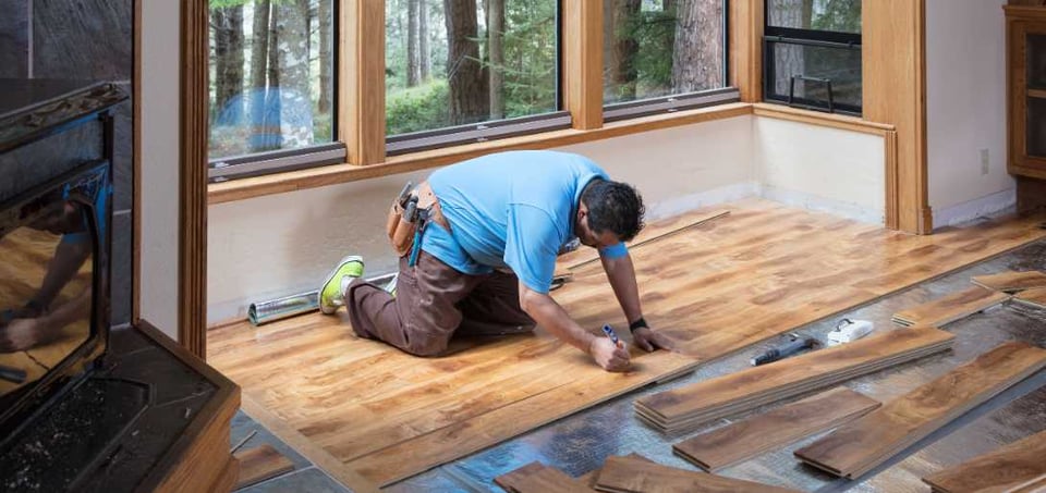 Man installing wooden flooring Image