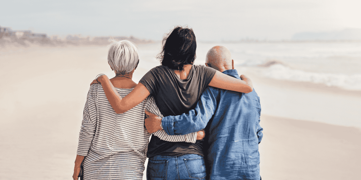 3 people on Beach supporting each other
